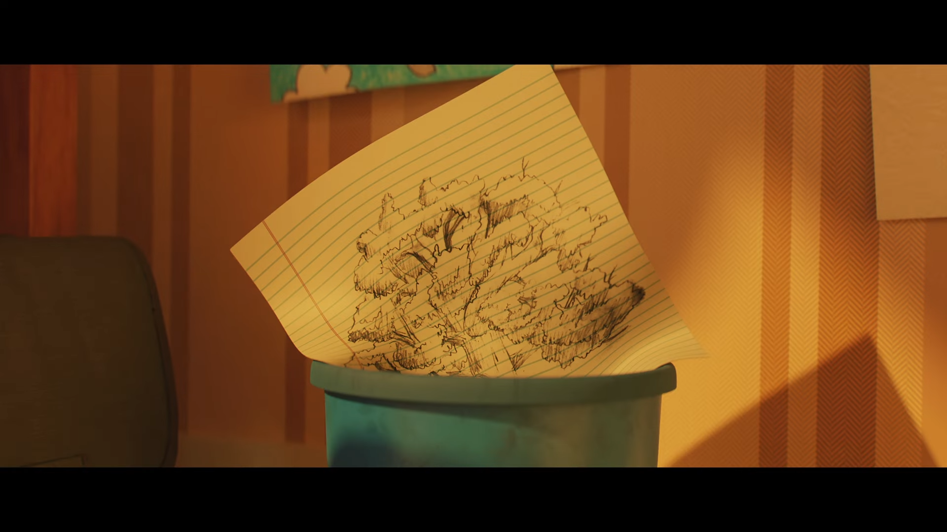 A wadded-up piece of paper with handwritten notes is being thrown into a green trash bin.