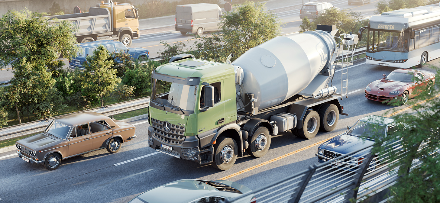 Busy highway with various vehicles including a green cement truck, classic cars, and modern vehicles amidst lush greenery.