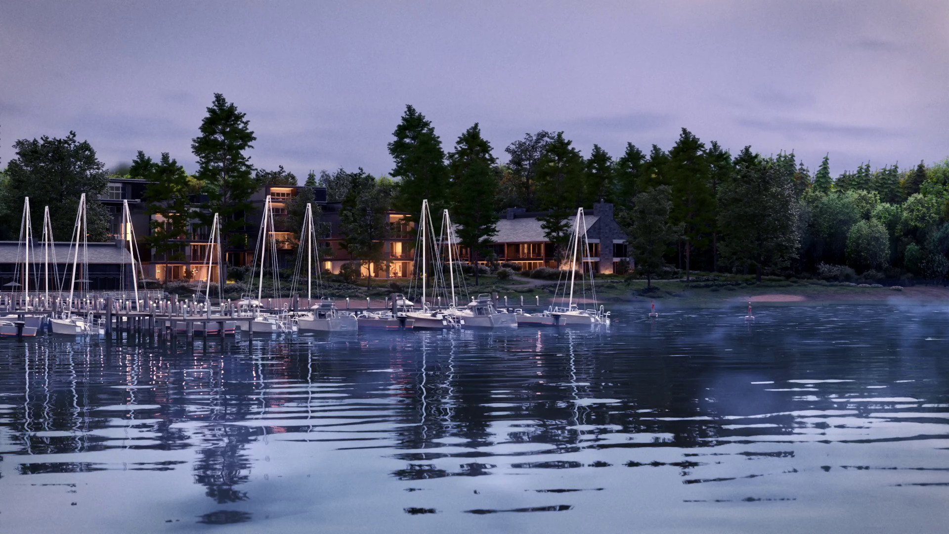 Calm marina at dusk with sailboats docked, reflecting on water, surrounded by buildings and trees.